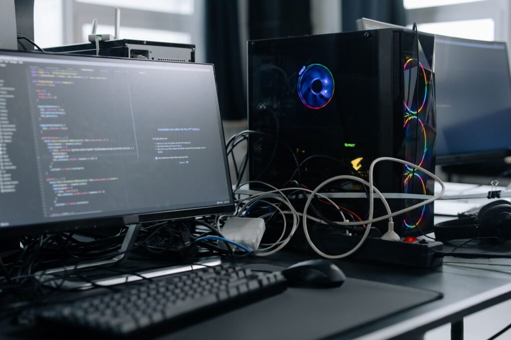 Small AI mini PC sitting next to a monitor on a desk